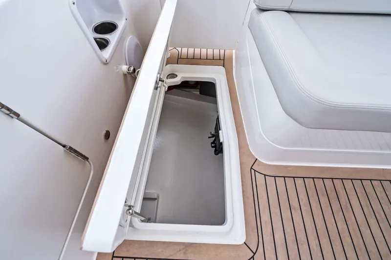 Tumalum Yacht Photos Pics Open storage compartment on 2023 MJM 35 boat with cushioned seating and cup holders.