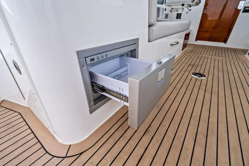 Tumalum Yacht Photos Pics Open drawer on 2023 MJM 35 yacht with sleek wooden deck.