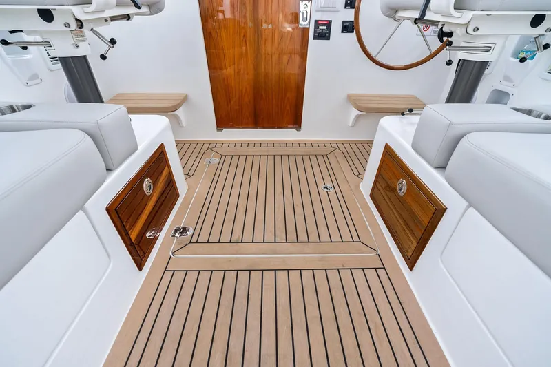 Tumalum Yacht Photos Pics 2023 MJM 35 boat interior with teak flooring and elegant seating.