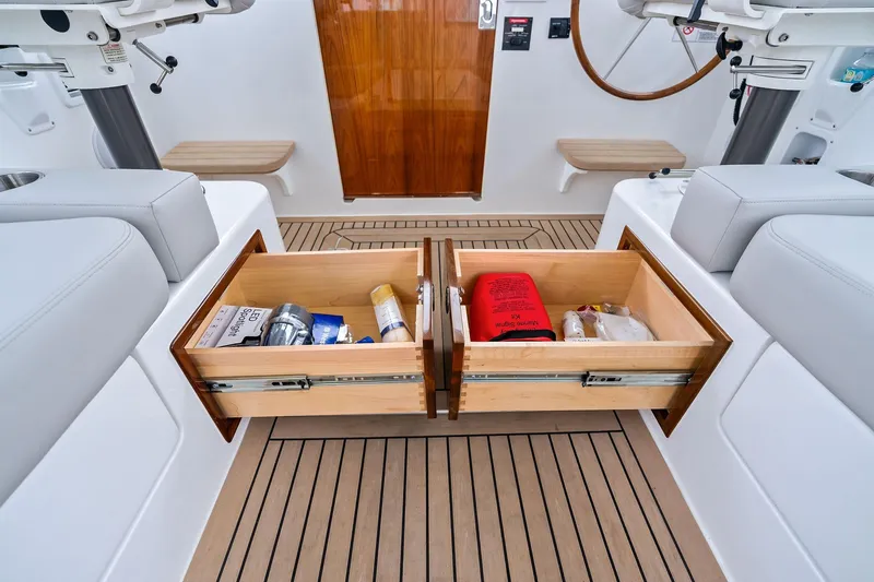 Tumalum Yacht Photos Pics 2023 MJM 35 boat interior with open storage drawers on teak flooring.