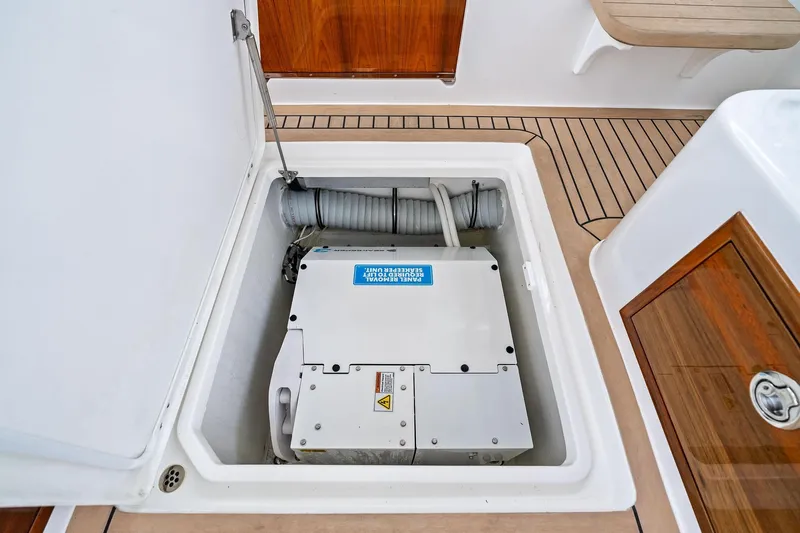 Tumalum Yacht Photos Pics 2023 MJM 35 boat engine compartment with visible machinery and wooden accents.