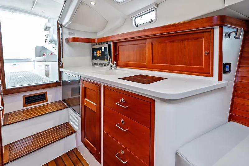 Tumalum Yacht Photos Pics Luxurious 2023 MJM 35 yacht interior with elegant wood cabinetry and modern amenities.