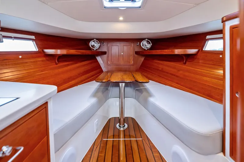Tumalum Yacht Photos Pics 2023 MJM 35 yacht interior with wooden finish and seating area.