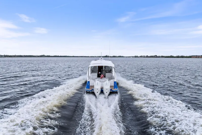 Tumalum Yacht Photos Pics 2023 MJM 35 boat cruising on open water under a clear blue sky.
