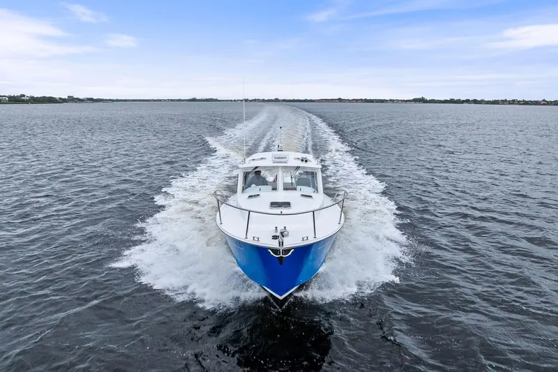 Tumalum Yacht Photos Pics 2023 MJM 35 boat cruising on open water under a clear blue sky.