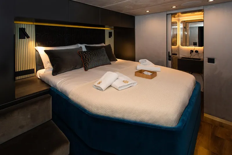 Mr.si. Yacht Photos Pics Luxurious bedroom interior of 2023 Sunreef 60 yacht with elegant bedding and modern design.