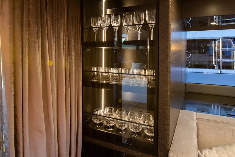 Mr.si. Yacht Photos Pics Luxurious interior of 2023 Sunreef 60 yacht featuring elegant glassware display.