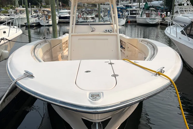  Yacht Photos Pics 2013 Grady-White Canyon 306 boat docked in a marina, surrounded by other vessels.