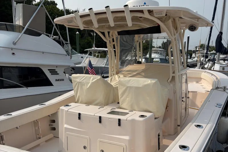  Yacht Photos Pics 2013 Grady-White Canyon 306 boat docked, featuring covered seating and American flag.