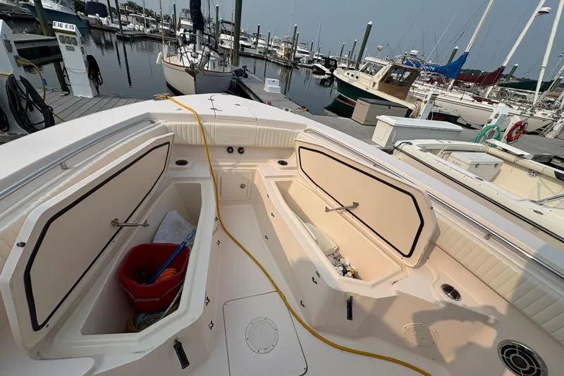  Yacht Photos Pics 2013 Grady-White Canyon 306 boat interior with open storage compartments at a marina.