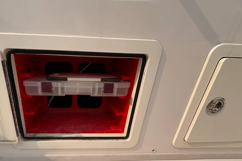  Yacht Photos Pics Storage compartment on a 2013 Grady-White Canyon 306 boat, featuring a red interior.
