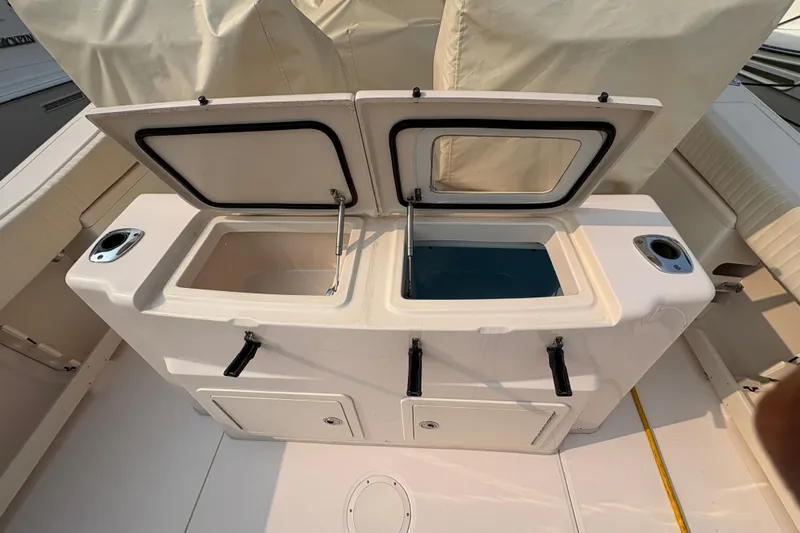  Yacht Photos Pics 2013 Grady-White Canyon 306 boat with open storage compartments and rod holders.