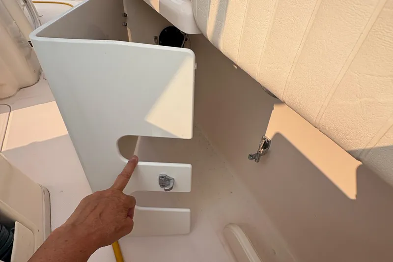  Yacht Photos Pics 2013 Grady-White Canyon 306 boat interior with hand pointing at compartment.