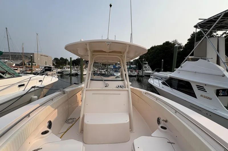  Yacht Photos Pics 2013 Grady-White Canyon 306 boat docked at marina, surrounded by other vessels.