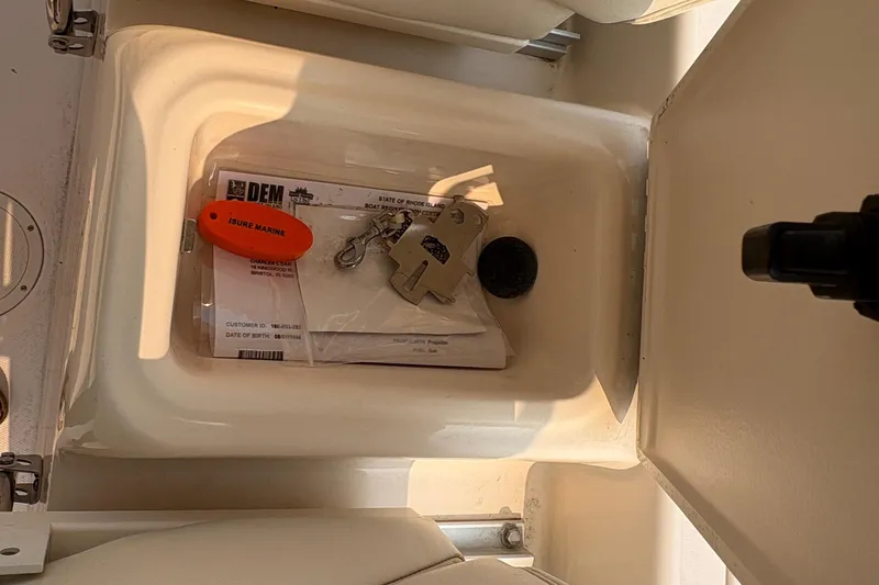  Yacht Photos Pics Open storage compartment on 2013 Grady-White Canyon 306 boat with keys and documents.