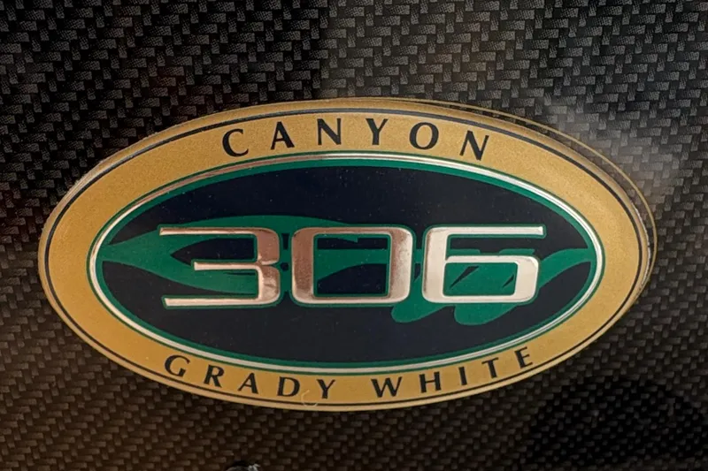  Yacht Photos Pics Grady-White Canyon 306 logo on carbon fiber background, 2013 model.