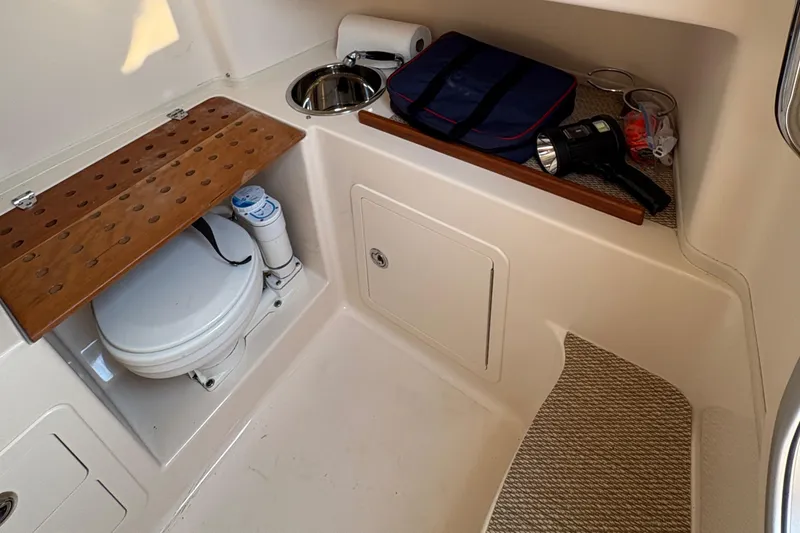 Yacht Photos Pics 2013 Grady-White Canyon 306 boat interior with toilet and storage area.