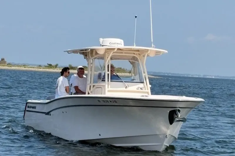  Yacht Photos Pics 2013 Grady-White Canyon 306 boat on water with three people onboard.