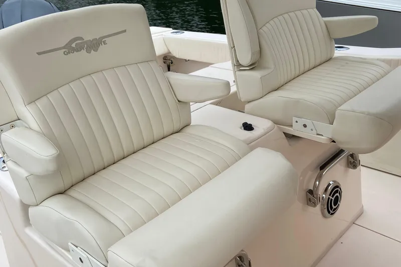  Yacht Photos Pics 2013 Grady-White Canyon 306 boat seats with armrests, featuring beige upholstery.