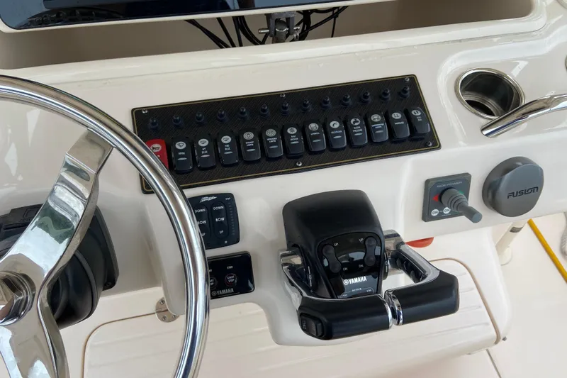  Yacht Photos Pics Control panel of 2013 Grady-White Canyon 306 boat with steering wheel and switches.