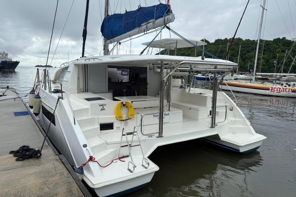 2016 Leopard 404 catamaran docked at marina, featuring spacious deck and modern design.