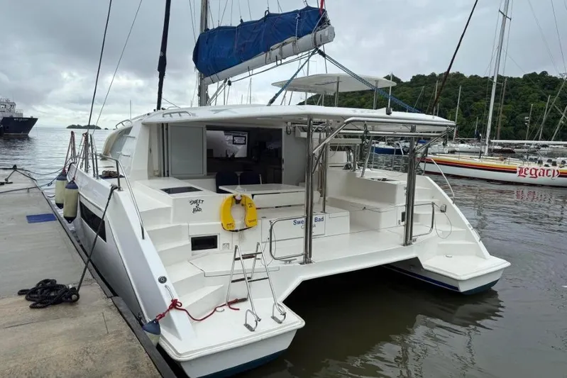 Sweet 2 Bad Yacht Photos Pics 2016 Leopard 404 catamaran docked at marina, featuring spacious deck and modern design.