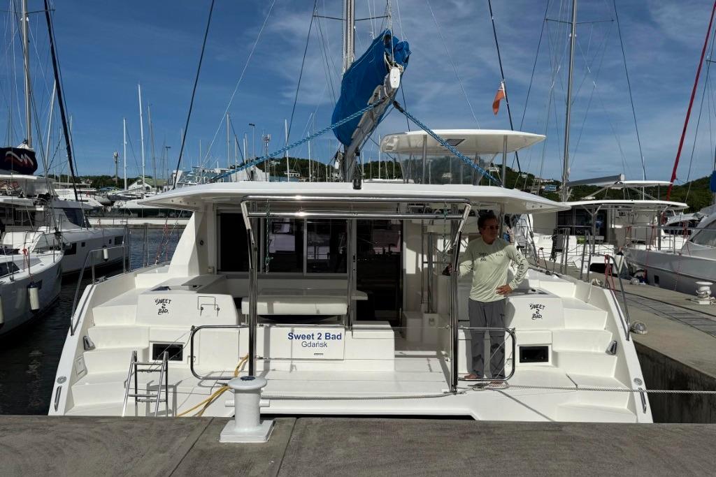 2016 Leopard 404 catamaran "Sweet 2 Bad" docked at marina with person on deck.