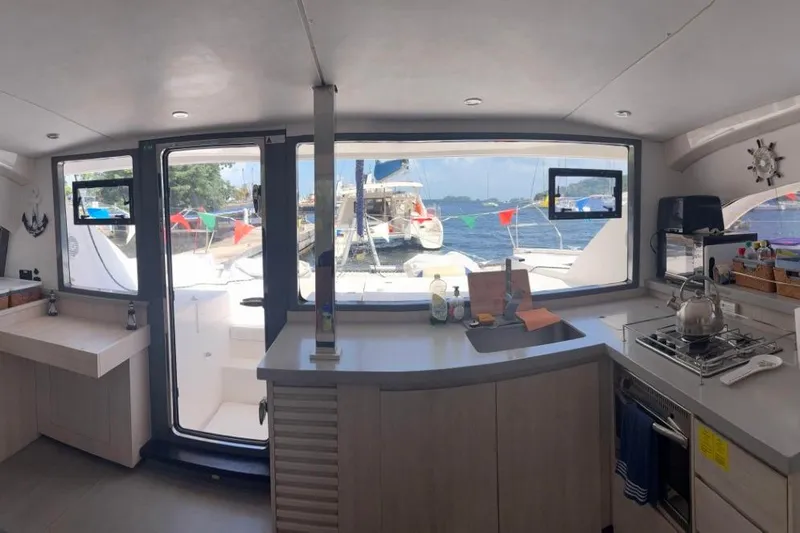 Sweet 2 Bad Yacht Photos Pics Interior of 2016 Leopard 404 yacht with kitchen and ocean view through large windows.