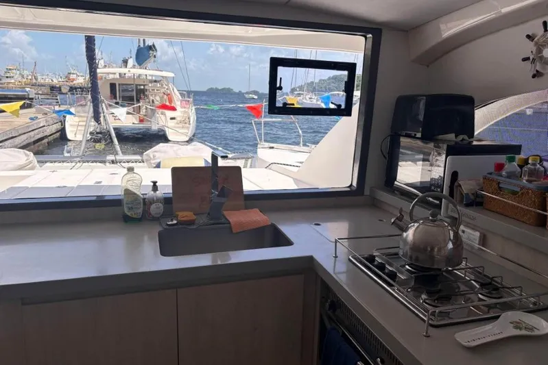 Sweet 2 Bad Yacht Photos Pics Interior of a Leopard 404 yacht kitchen with marina view through window.