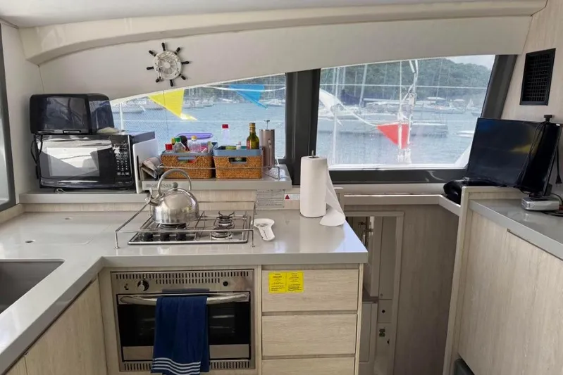 Sweet 2 Bad Yacht Photos Pics Modern kitchen inside a 2016 Leopard 404 yacht with appliances and sea view.