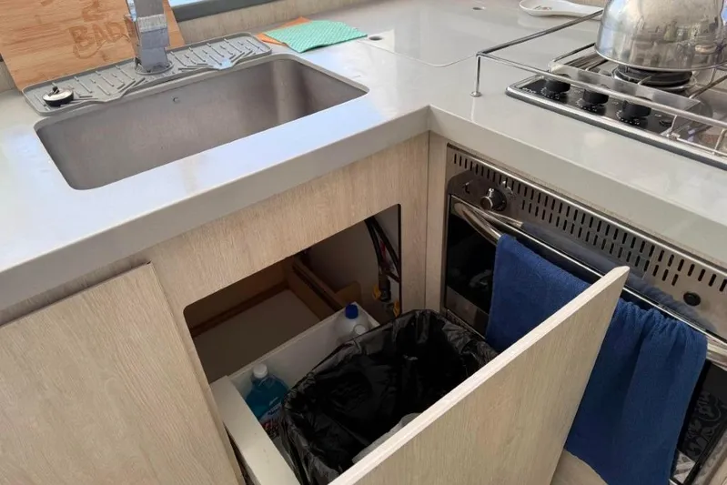 Sweet 2 Bad Yacht Photos Pics Modern kitchen setup in a Leopard 404, featuring sink, stove, and storage.