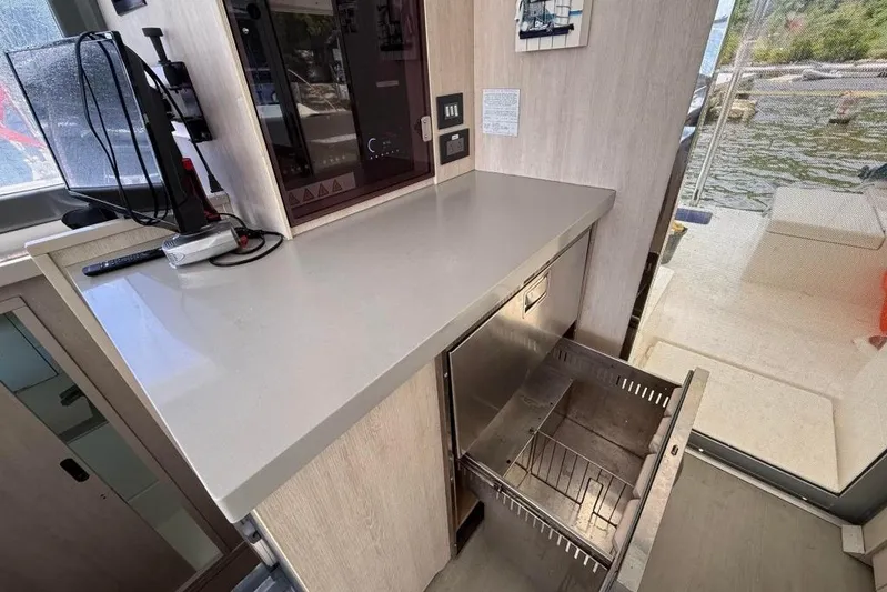 Sweet 2 Bad Yacht Photos Pics Modern kitchen area in a 2016 Leopard 404 yacht with open drawer and appliances.