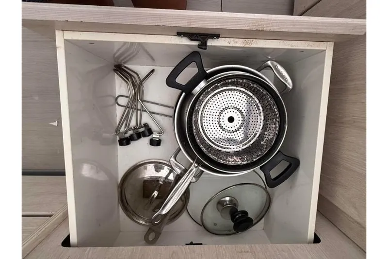 Sweet 2 Bad Yacht Photos Pics Kitchen drawer with pots, lids, and utensils in a Leopard 404, 2016 model.