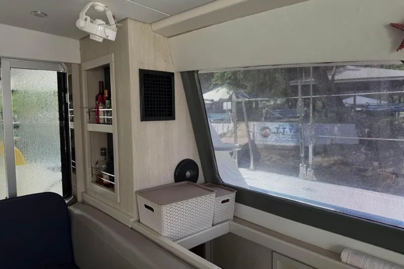 Sweet 2 Bad Yacht Photos Pics Interior of a 2016 Leopard 404 yacht with storage shelves and window view.