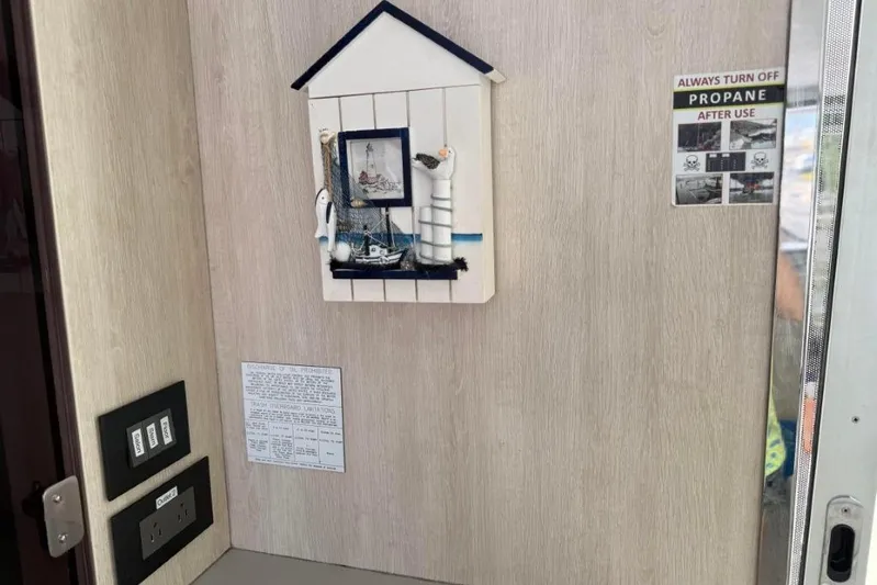 Sweet 2 Bad Yacht Photos Pics Wall decor with nautical theme and propane safety sign in Leopard 404, 2016 model.