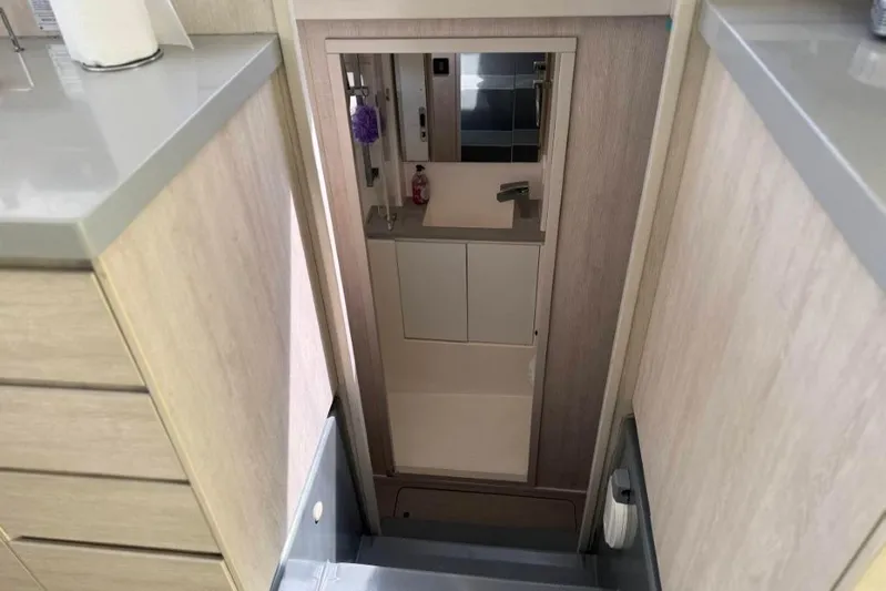 Sweet 2 Bad Yacht Photos Pics Compact bathroom in a 2016 Leopard 404 yacht, featuring modern fixtures and storage.