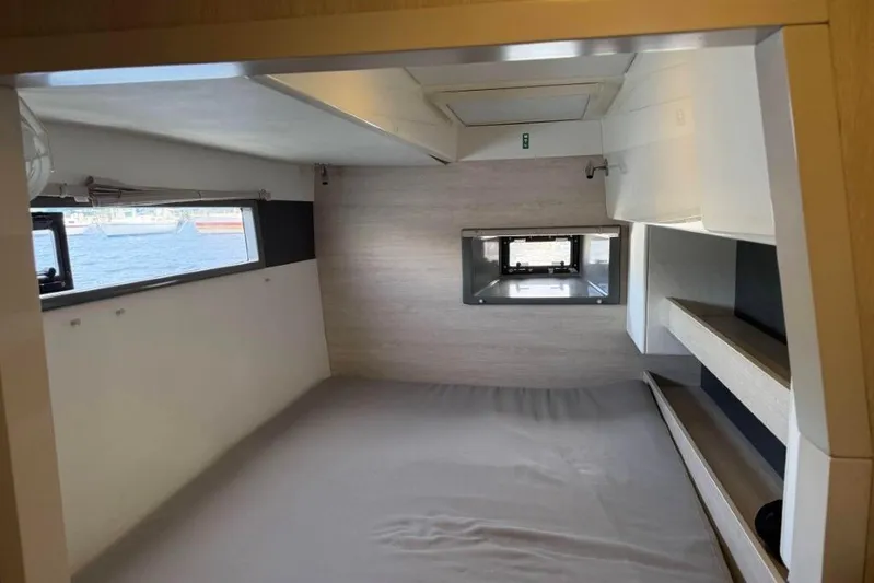 Sweet 2 Bad Yacht Photos Pics Interior cabin of a 2016 Leopard 404 catamaran with windows and storage shelves.
