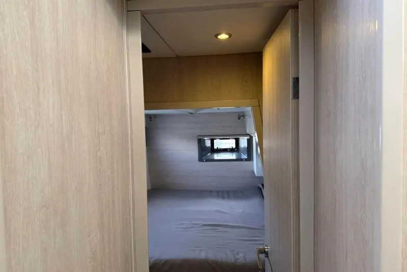 Sweet 2 Bad Yacht Photos Pics Compact bedroom interior in a 2016 Leopard 404 yacht, featuring a cozy bed and window.