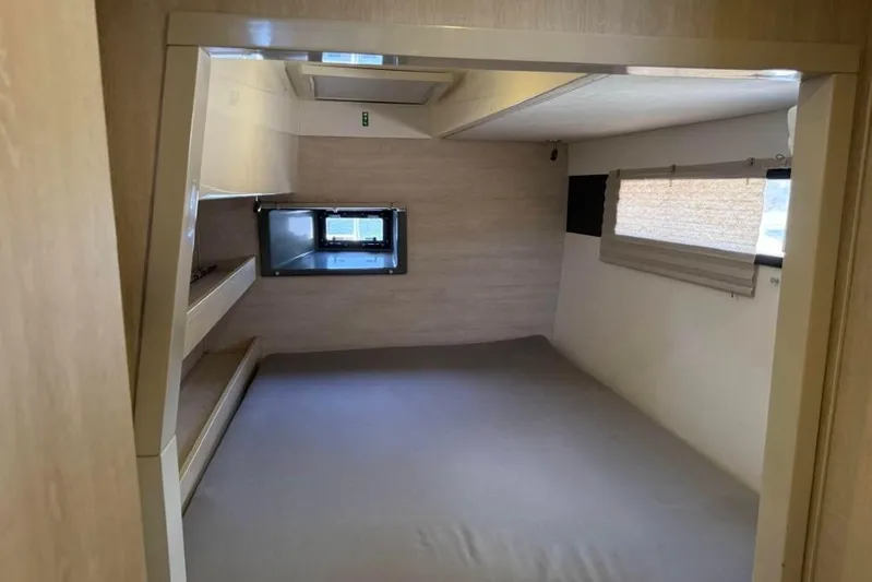 Sweet 2 Bad Yacht Photos Pics Compact interior of a 2016 Leopard 404 camper with window and storage shelves.