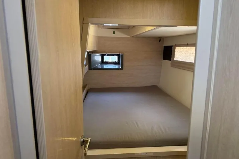 Sweet 2 Bad Yacht Photos Pics Compact bedroom interior in a 2016 Leopard 404, featuring a cozy bed and small window.