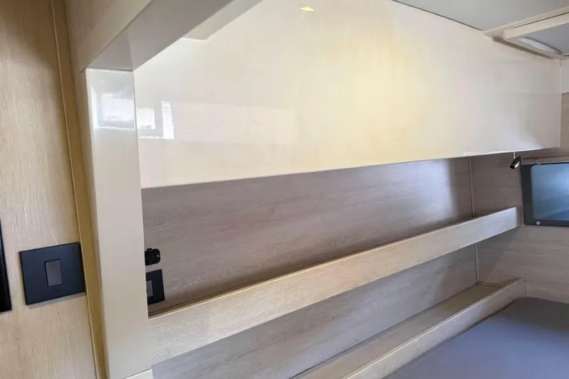 Sweet 2 Bad Yacht Photos Pics Modern interior of a 2016 Leopard 404 yacht with sleek wooden shelves.