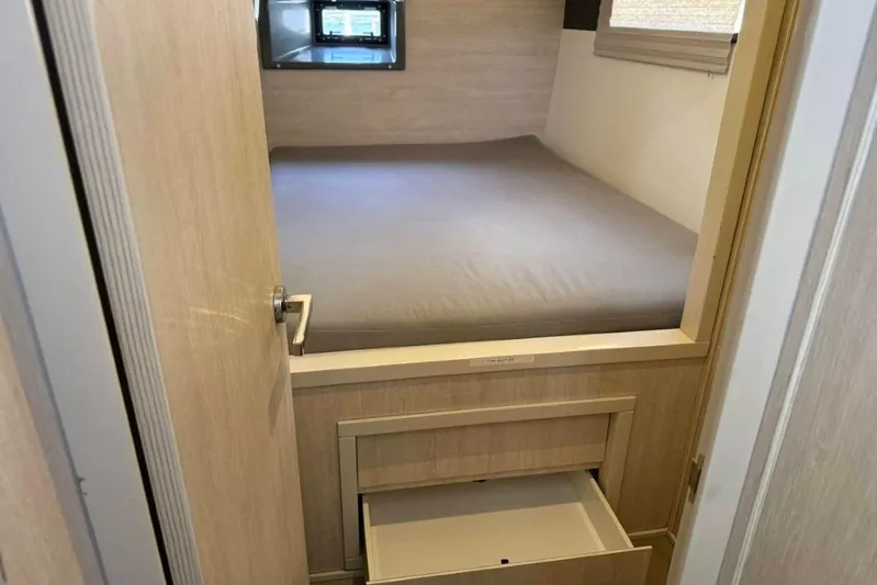 Sweet 2 Bad Yacht Photos Pics Compact bedroom in a 2016 Leopard 404 with storage drawer and window.