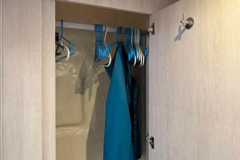 Sweet 2 Bad Yacht Photos Pics Open closet with blue hangers and a jacket inside a Leopard 404, 2016 model.