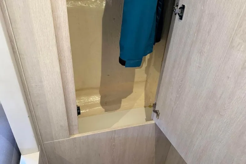 Sweet 2 Bad Yacht Photos Pics Open closet in Leopard 404, 2016 model, with hanging blue jacket.