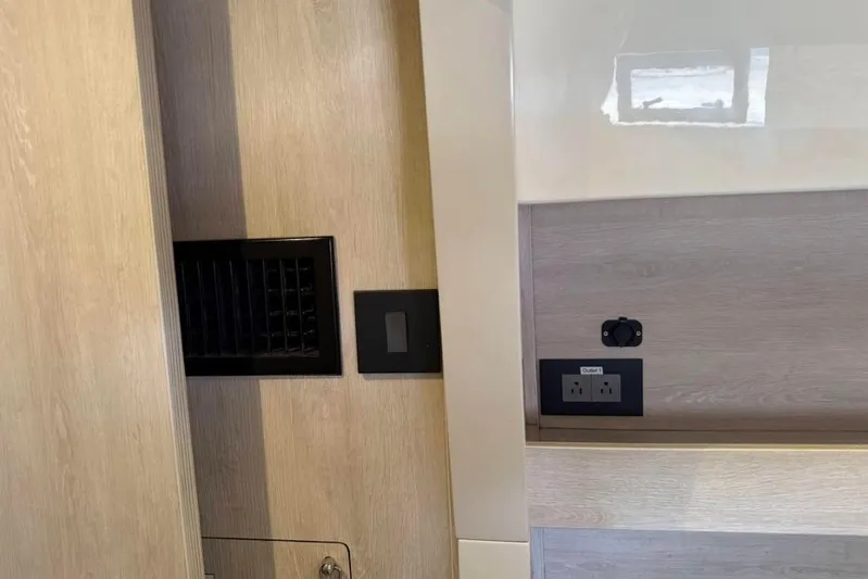 Sweet 2 Bad Yacht Photos Pics Interior of 2016 Leopard 404 with wood paneling and electrical outlets.