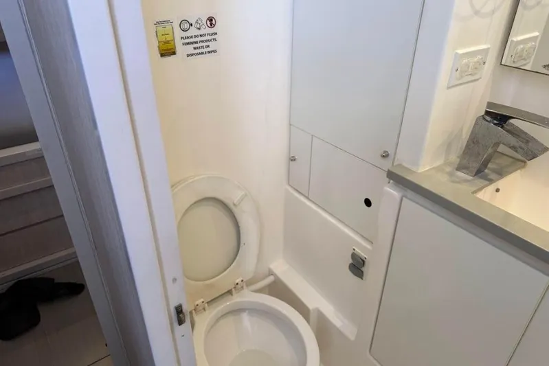 Sweet 2 Bad Yacht Photos Pics Compact bathroom in a 2016 Leopard 404, featuring a toilet and modern sink.