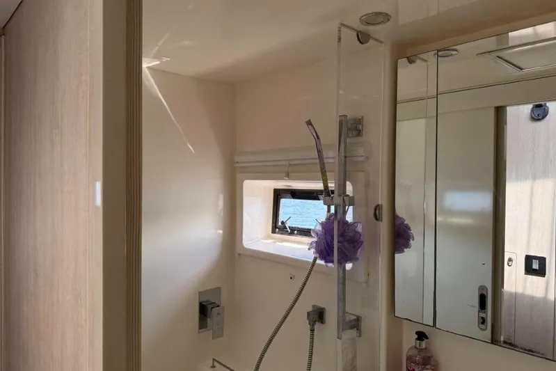 Sweet 2 Bad Yacht Photos Pics Modern bathroom interior on a 2016 Leopard 404 yacht, featuring a shower and window.