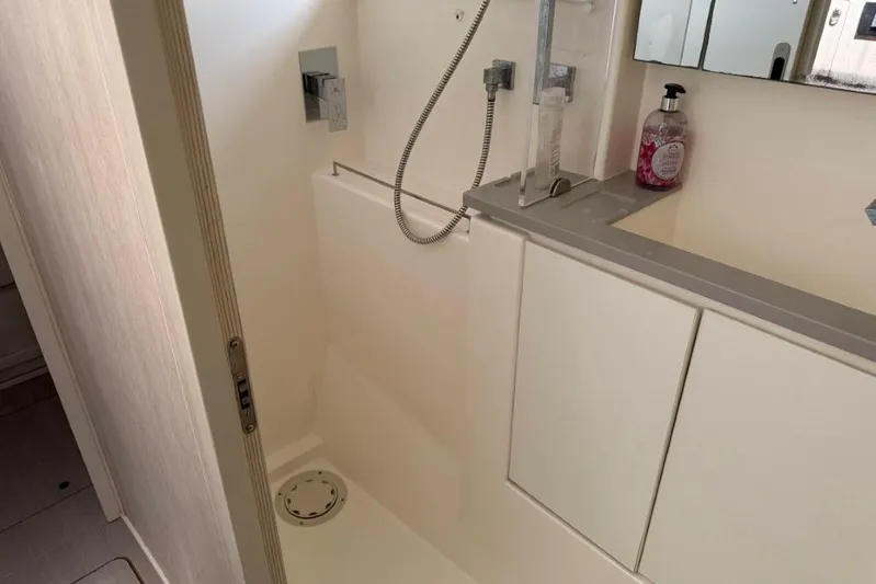 Sweet 2 Bad Yacht Photos Pics Compact bathroom in a 2016 Leopard 404 yacht with modern fixtures and soap dispenser.