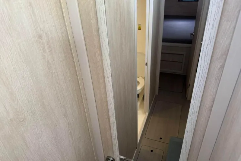 Sweet 2 Bad Yacht Photos Pics Narrow hallway in 2016 Leopard 404 yacht, leading to bathroom and cabin.