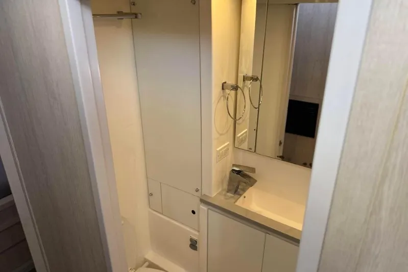 Sweet 2 Bad Yacht Photos Pics Compact bathroom interior in a 2016 Leopard 404 model, featuring modern fixtures and mirror.